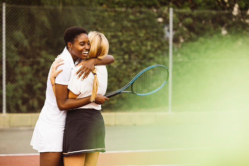 Woman in a classic white tennis dress — timeless tennis wardrobe essentials from The Court Society