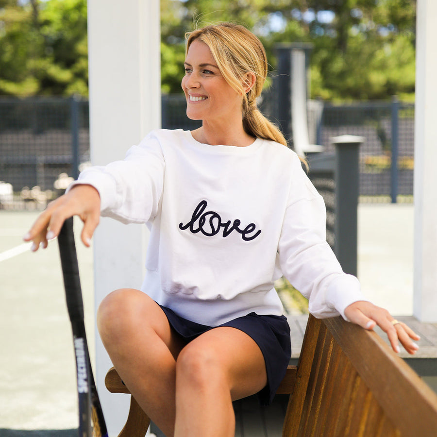 Ame & Lulu — Woman by a court in the Love Stitched sweatshirt